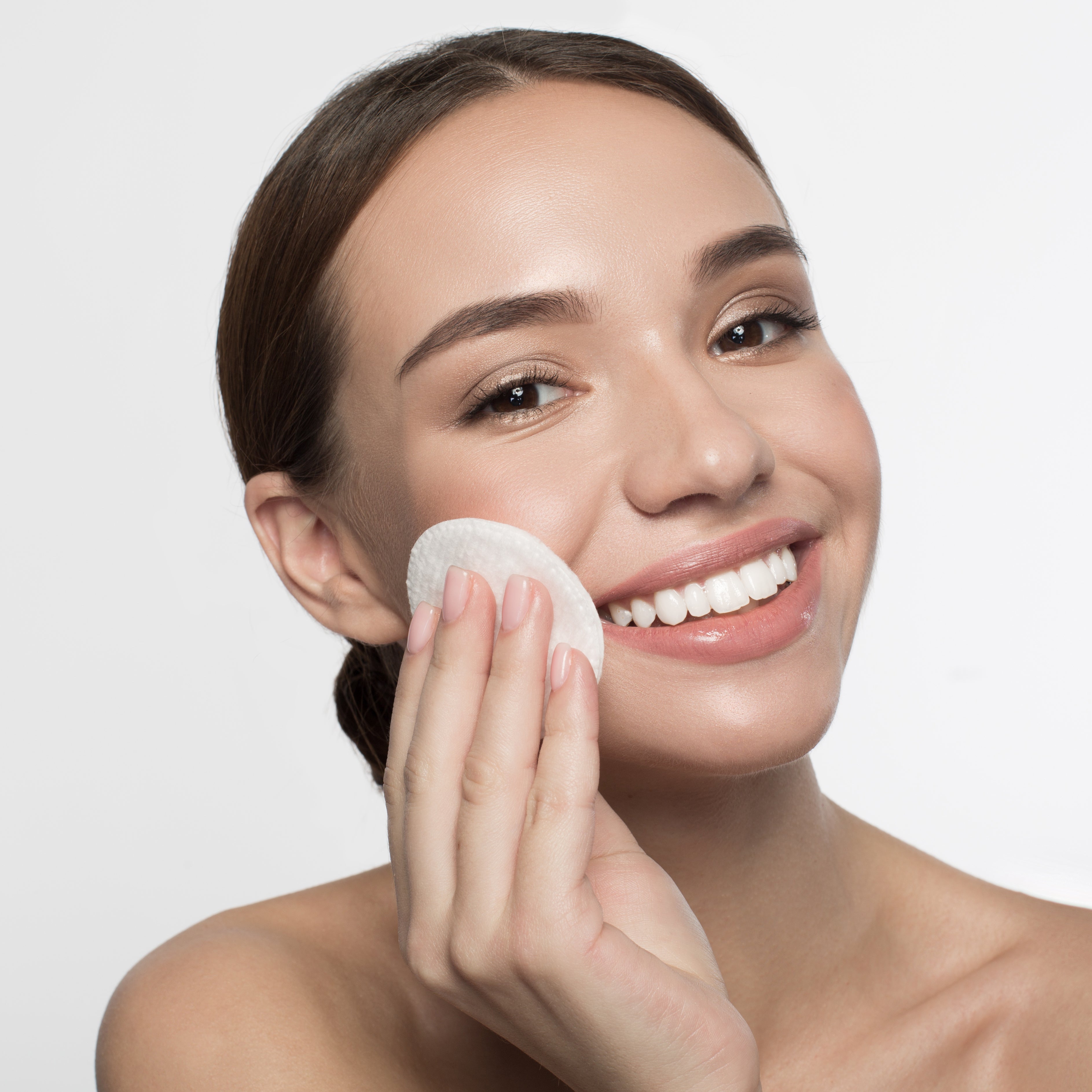Woman using brightening pads on her face